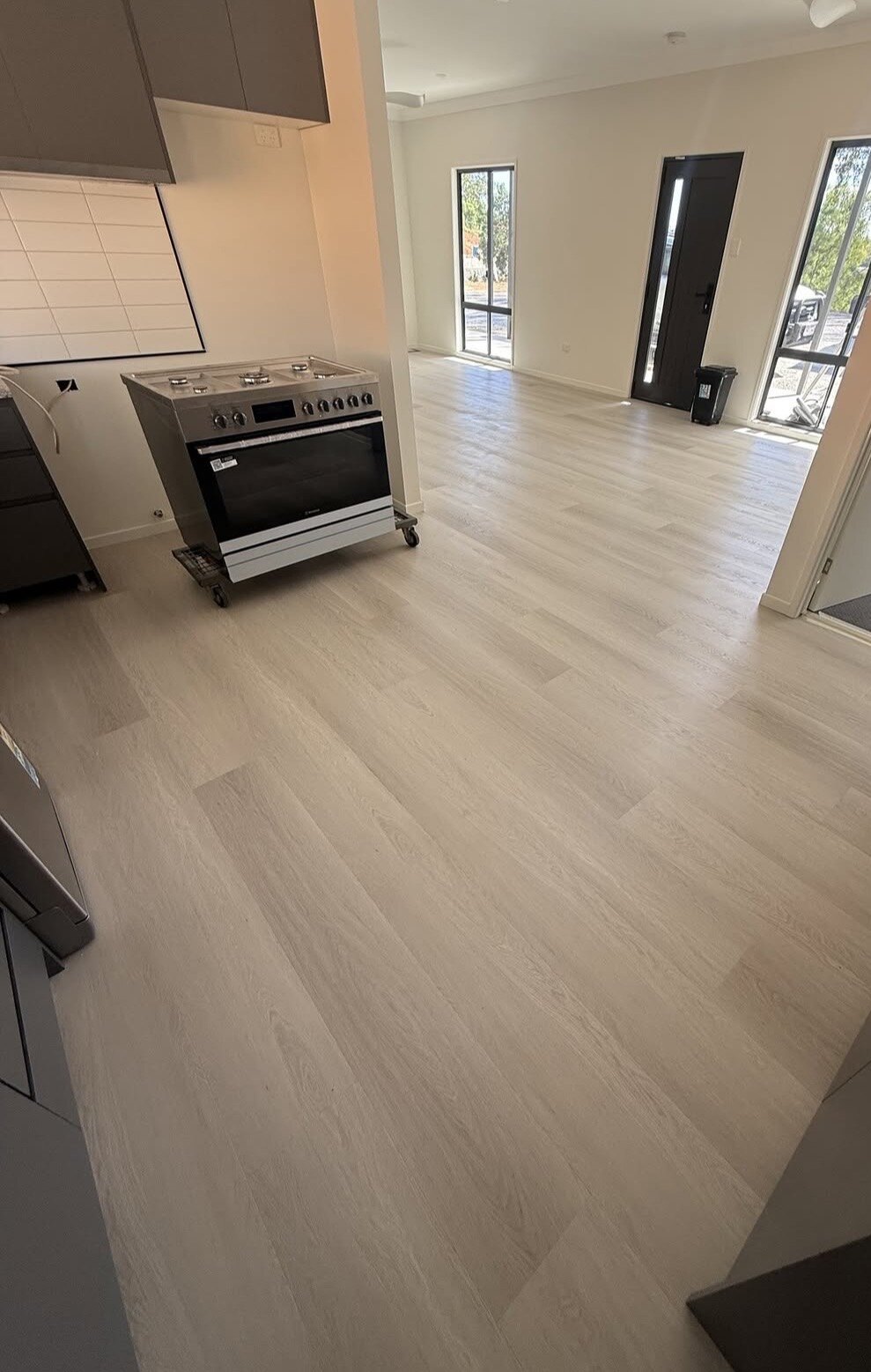 Light flooring completed through a kitchen and living area