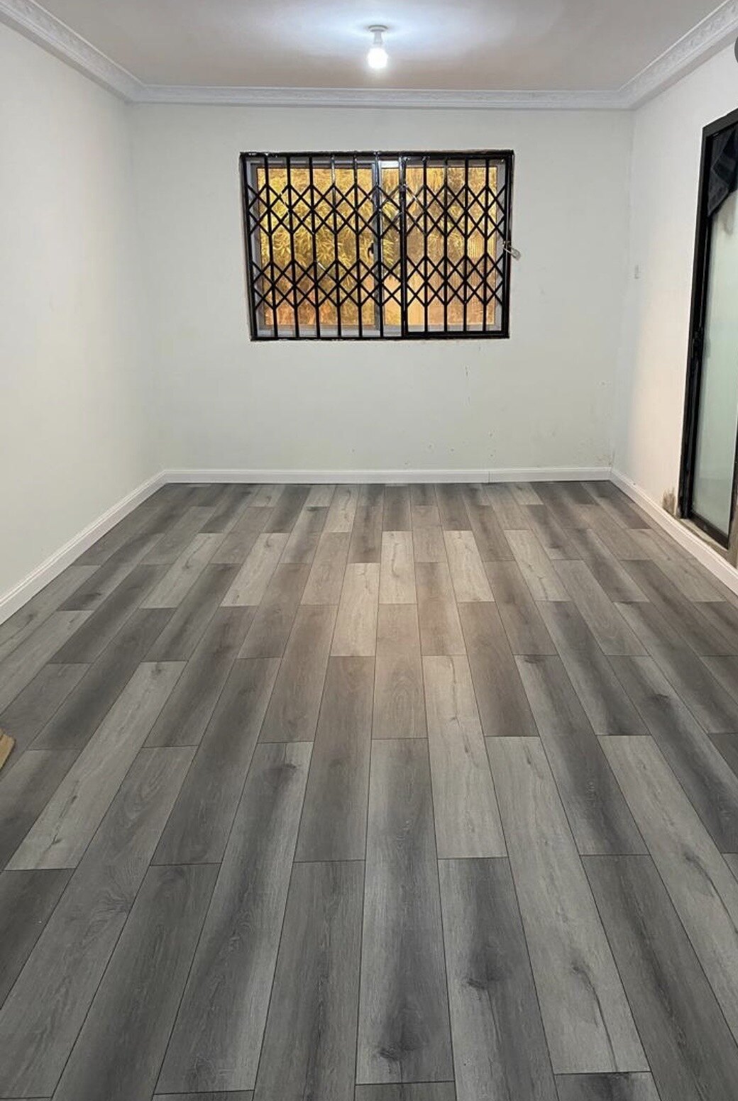 Gray flooring completed in a room with crown molding